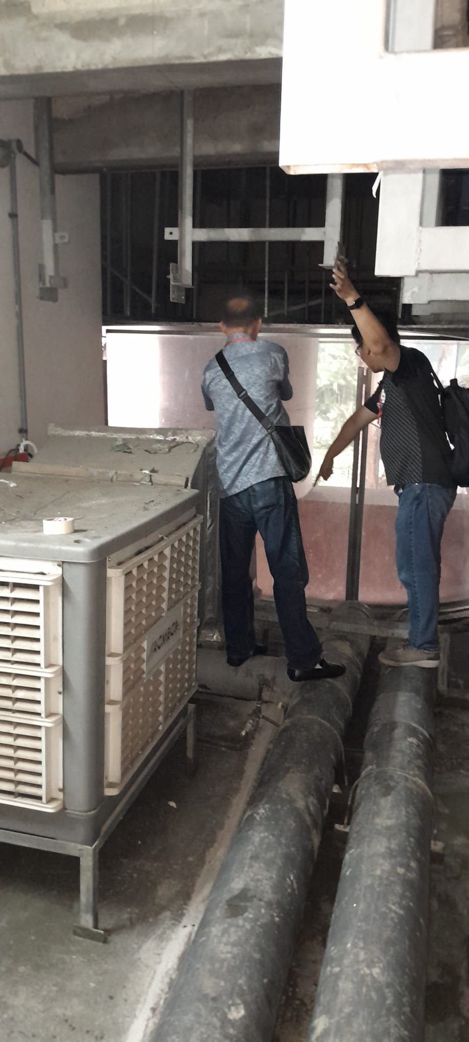 Winsteam engineers inspecting cooling equipment and pipework during ACMV installation