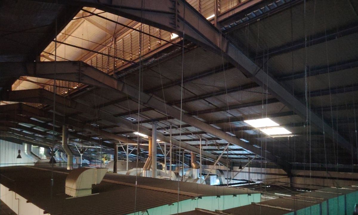 Spiral exhaust ducting installed by Winsteam across a factory production hall in Singapore