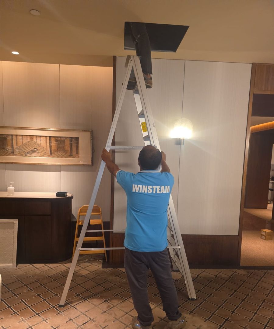 Winsteam technicians accessing ceiling ACMV ductwork in an operating Singapore hotel