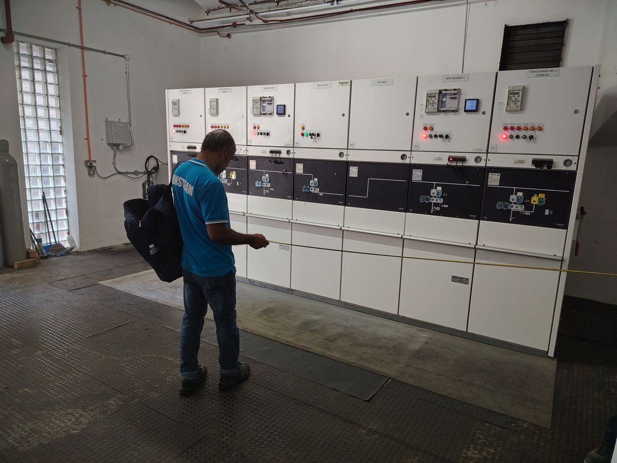 Winsteam technician in an LV switchboard room during M&E works in Singapore